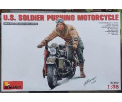 U.S Soldier pushing motorcycle